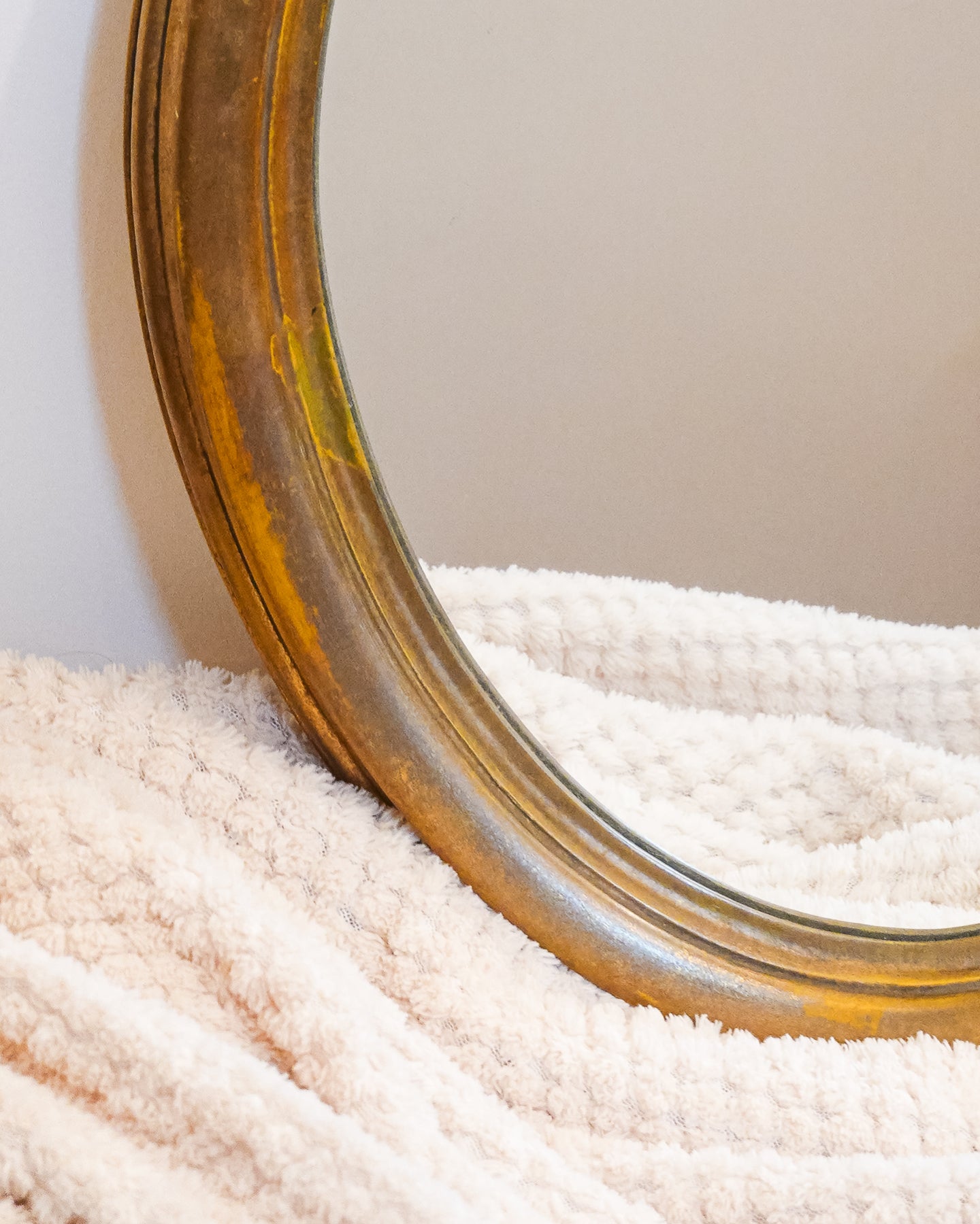 Miroir mural ancien ovale avec cadre en bois patiné, charme classique et authentique